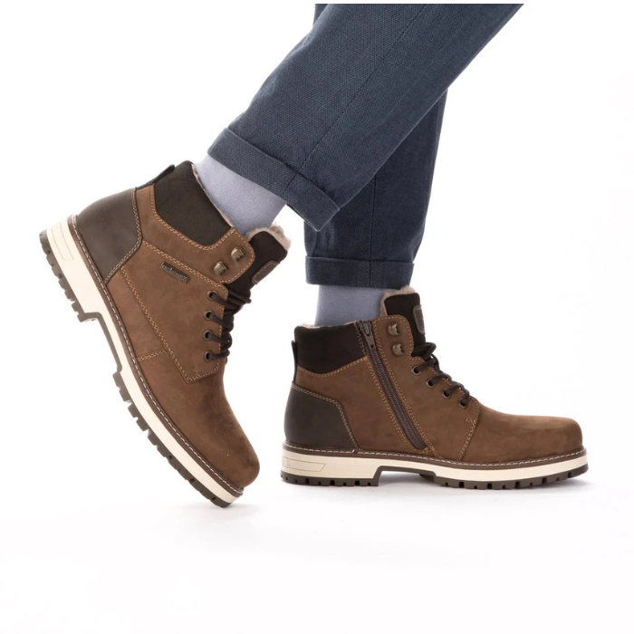 Brown winter ankle boots worn with grey pants.