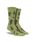 Green socks with Bigfoot, tree, and footprint pattern.