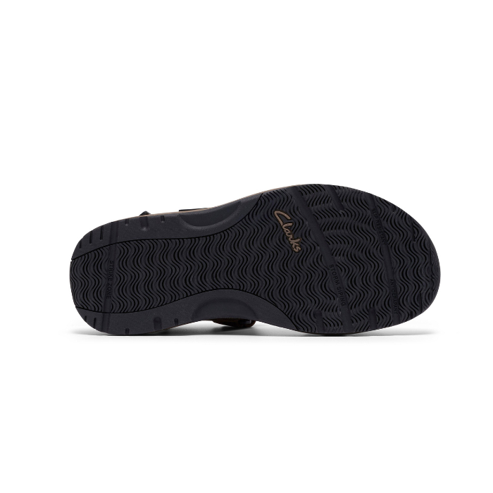 Black light treaded outsole of walking sandal with Clarks logo stamped in gold.