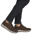 Brown shoes worn with dark jeans.