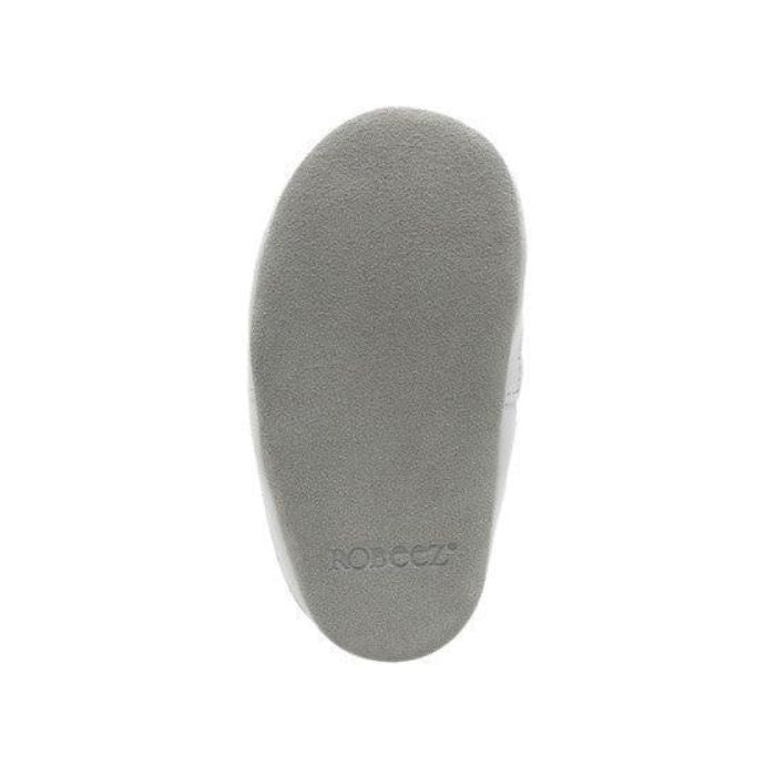 Grey suede outsole of baby shoe.
