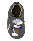 Gray baby shoe with soft solefeaturing airplane and clouds with checkered and striped fabric details.