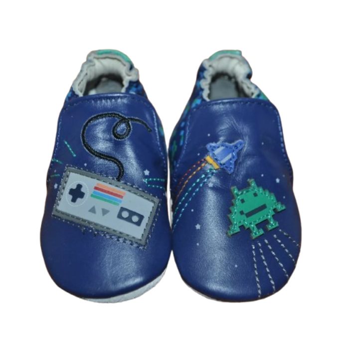 Pair of Blue baby shoes with soft soles featuring retro a game controller, spaceship, and pixelated alien designs.