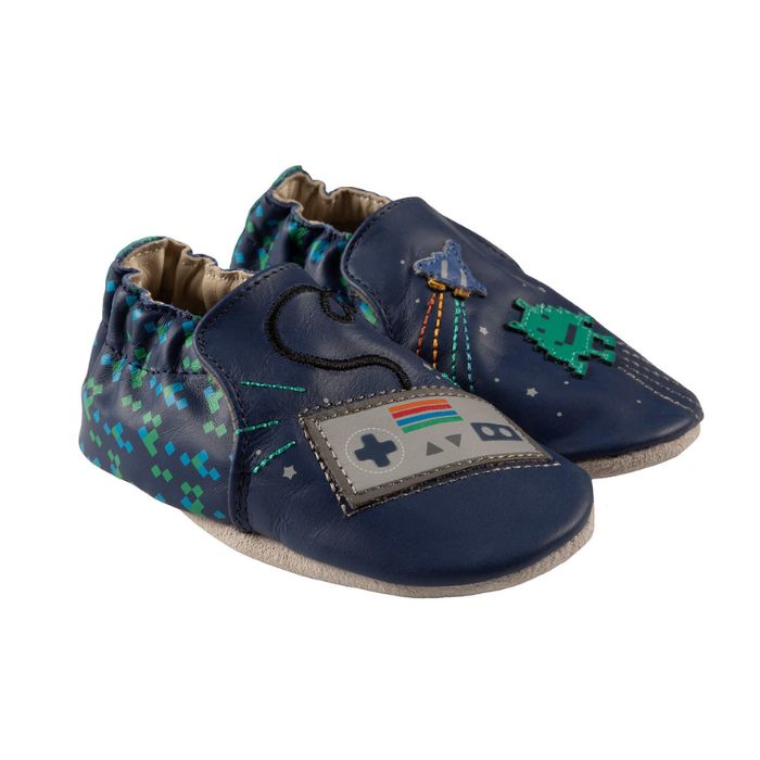 Pair of Blue baby shoes with soft soles featuring retro a game controller, spaceship, and pixelated alien designs.
