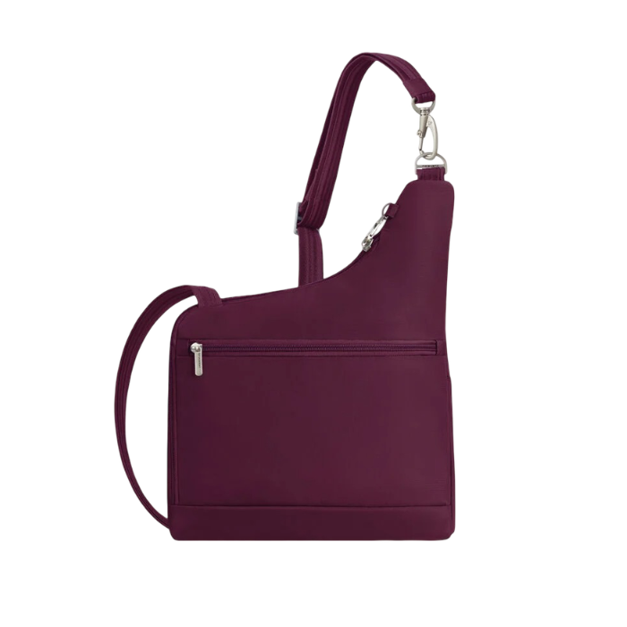Back of a burgundy nylon shoulder bag with zippered pockets and a silver metal carabiner.
