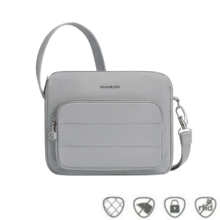 Light gray Travelon Anti-Theft Roam E/W Crossbody Bag with front zip pocket and anti-theft icons, ideal for secure urban travel.