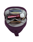 Interior of plum travel organizer sling bag with grey lining pockets for a passport and cards and other items.