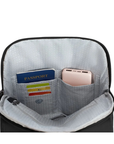 Open view of a black backpack with light grey interior pockets showing passport, cards, and a pink power bank.