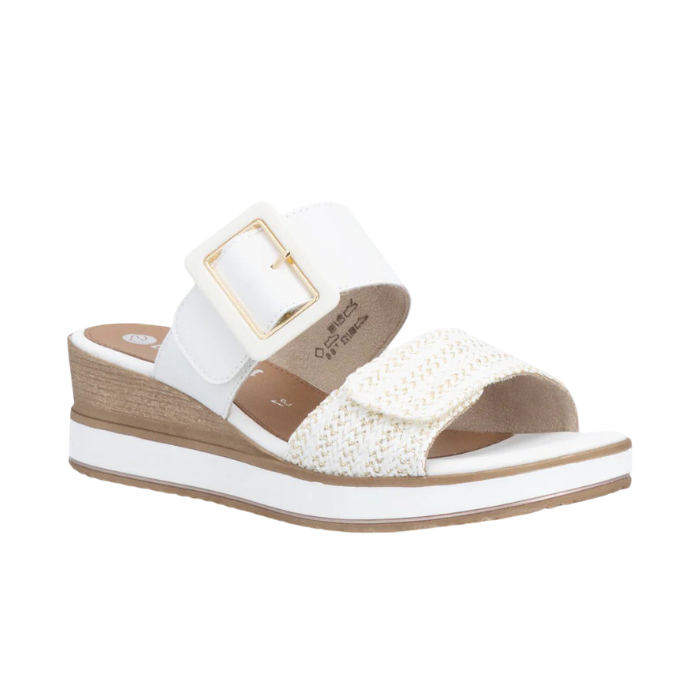 White wedge slide sandal with a white buckle strap, gold accents, woven over-the-toe Velcro strap, tan Remonte logo'd footbed, white midsole and tan outsole.