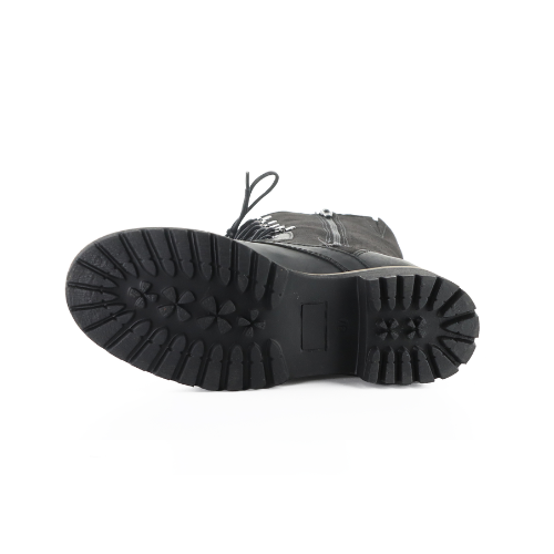 Outsole of tall boot with lugged outsole, lace and zipper seen from side.