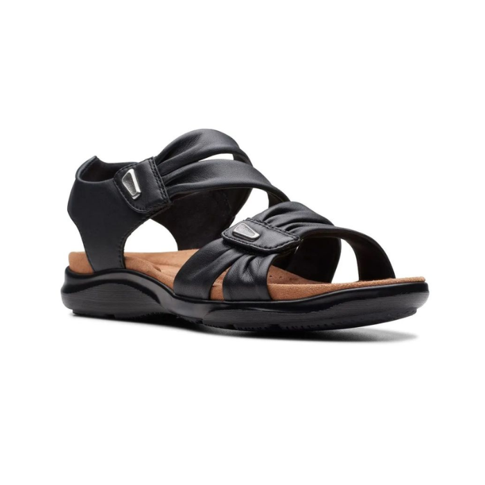 Black backstrap sandal with two adjustable Velcro straps with scrunched details, small silver embellishments, tan Clarks logo'd footbed and black outsole.
