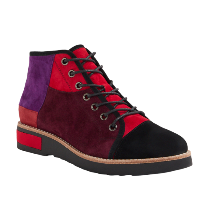 A high-top patchwork ankle boot featuring suede panels in red, burgundy, purple, and black, with black laces and a black outsole.