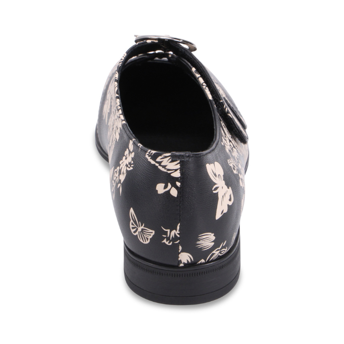 Heel of Black dress shoe with brown floral pattern and two velcro straps with detail buckles.