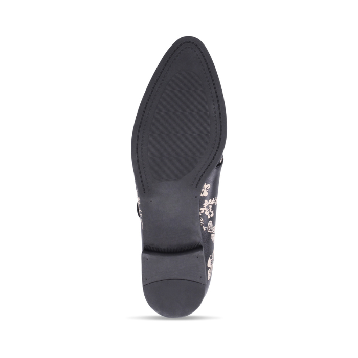 Black outsole of dress shoe with low heel.