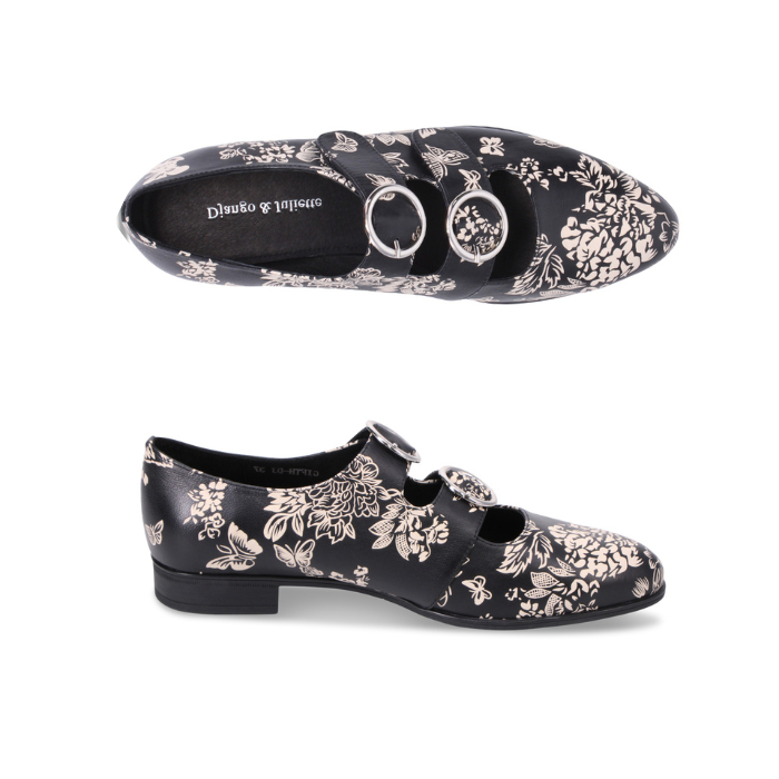 Pair of Black dress shoe with brown floral pattern and two velcro straps with detail buckles.