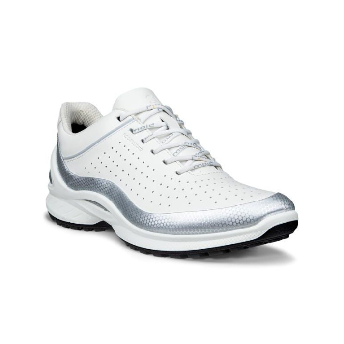 White athletic shoe with decorative perforations, silver accents and black outsole.