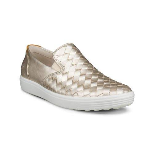 An Ecco Slip-On Sneaker with gold thatched appearance with a smooth leather gold heel and a white outsole. 