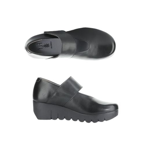 Pair of black Mary-Jane style shoes with a Velcro strap, Fly London logo on grey footbed and a thick lugged rubber sole.
