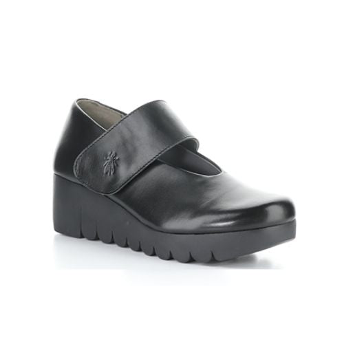 A black Mary-Jane style shoe with a Velcro strap and a thick lugged rubber sole.