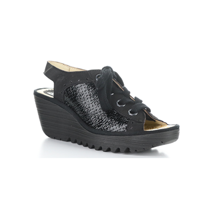 Black wedge sandal with patent accents, lace closure, open heel and toe and a lugged platform outsole.