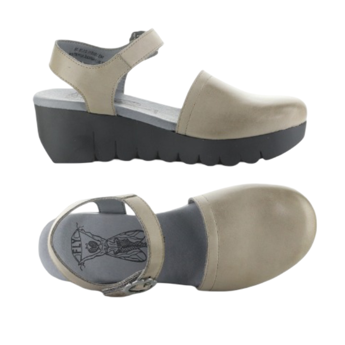 Pair of Taupe closed toe sandals with backstrap, grey Fly London logo'd footbed and a lugged black wedge platform.