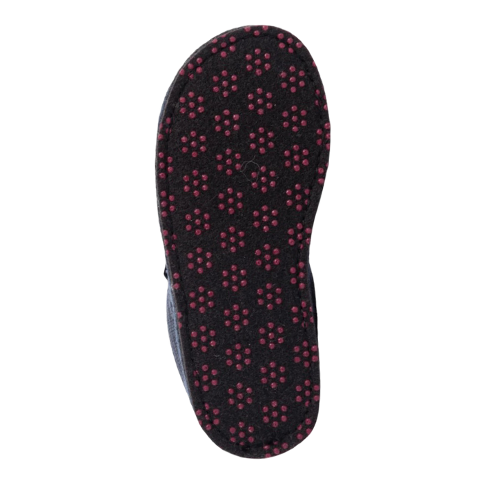 Outsole of a black slipper with repeating pattern of small red circular dots (traction dots).