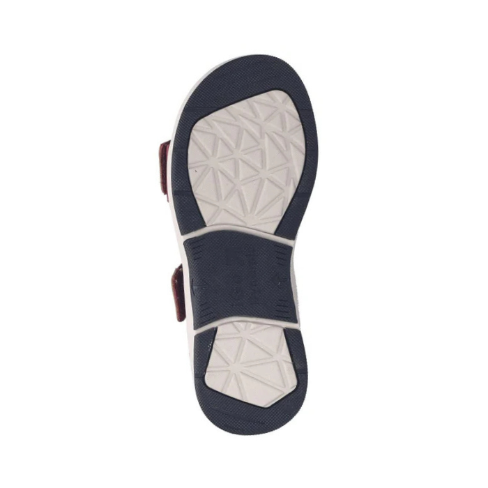 Navy and white outsole of sandal with geometric tread patterns.