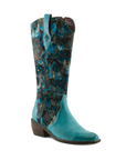 A tall western cowboy boot with a teal blue floral patterned shaft and a solid teal blue embossed leather vamp with silver studded wrap detail and low block heel.