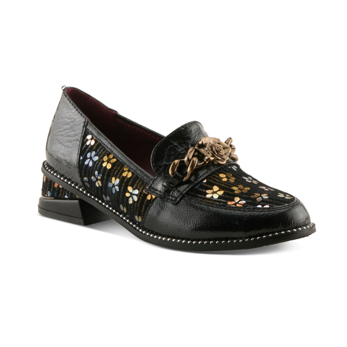 A glossy black leather loafer with dark yellow and blue floral pattern on the side panels, a decorative burnished gold metal rose on chain embellishment on the vamp, and black sculptured low block heel.