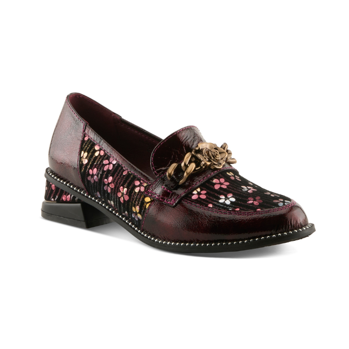 A glossy burgundy leather loafer with floral pattern on the side panels, a decorative burnished gold metal rose on chain embellishment on the vamp, and black sculptured low block heel.