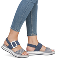 Navy and white backstrap sandal worn with blue jeans.