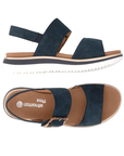 Pair of Navy backstrap sandals with brown marble buckle, tan Remonte logo'd footbed and white outsole.