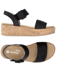 Pair of Black wedge sandals with  black woven toe strap, buckled back strap, tan Remonte logo's footbed, faux cork midsole and tan outsole.