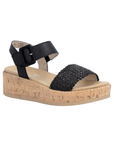 Black wedge sandal with  black woven toe strap, buckled back strap, tan Remonte logo's footbed, faux cork midsole and tan outsole.