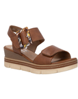 Brown backstrap platform sandal with oversized decorative buckle, two Velcro straps, Remonte logo'd footbed, a faux wood grain wedge midsole and  an off-white outsole.