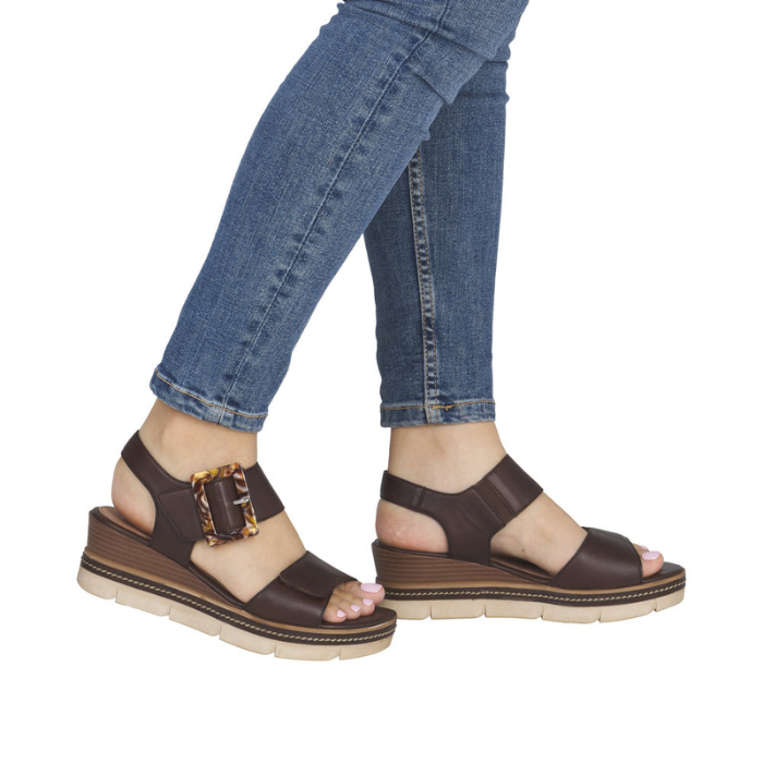 Dark Brown wedge sandals worn with blue jeans.