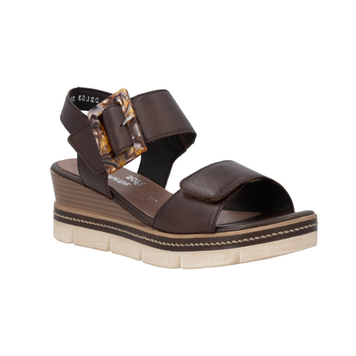 Dark Brown backstrap platform sandal with oversized decorative buckle, two Velcro straps, Remonte logo'd footbed, a faux wood grain wedge midsole and  an off-white outsole.