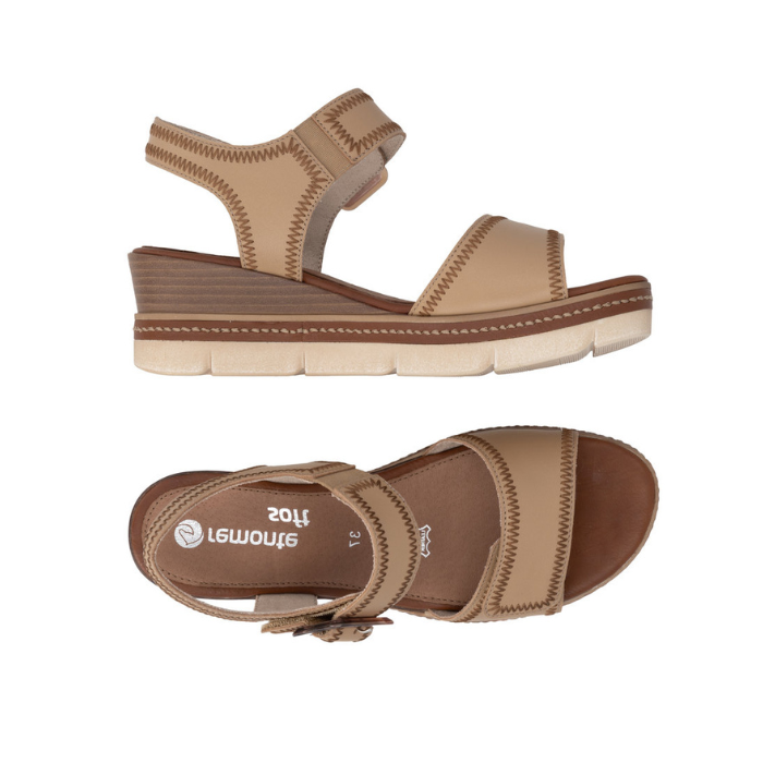 Pair of Tan wedge sandals with brown buckle, accent zig-zag stitching, tan Remonte logo'd footbed and tan-white outsole.
