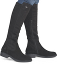 Black knee-high boots worn with blue jeans.