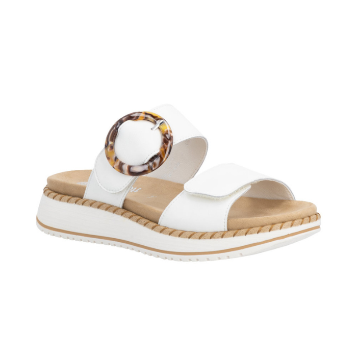 White slide sandal with two Velcro straps, marbled circle buckle, tan Remonte logo'd footbed, and a white platform with beige accents.