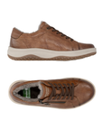 Pair of  brown leather sneakers with a side zipper, brown laces,  cream-colored midsole, fur lining and tan treaded outsole.