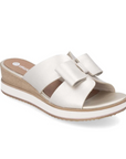 Women's Rieker D6456 slide platform wedge in beige with bow accents and wood-textured heel, perfect for summer outfits.