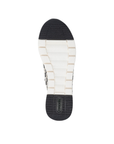 White light treaded outsole with black toe and heel sections and green Remonte logo on heel.