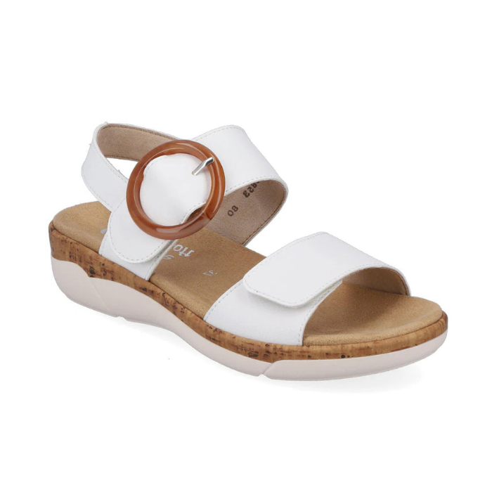 Rieker R6853 Backstrap Sandal in white with large brown buckle, featuring adjustable straps and cork-textured sole for lightweight comfort.