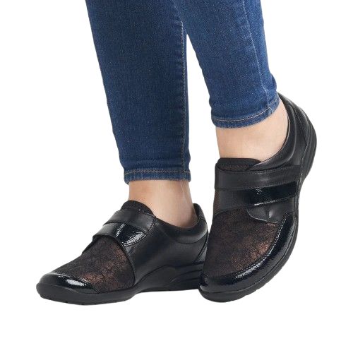 Model wearing lace-patterned black Women&#39;s Remonte R7600 Velcro Shoes, perfect for casual comfort and stylish support.