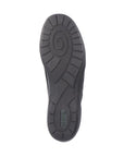Black rubber outsole of women's shoe with green Remonte logo on heel.