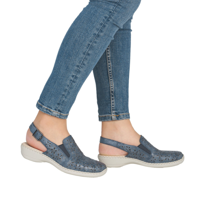Blue sandals worn with rolled-up jeans.