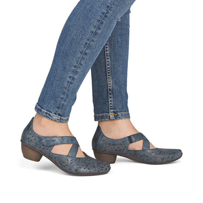 Blue heeled Mary Jane shoes worn with blue jeans.