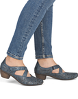Blue heeled Mary Jane shoes worn with blue jeans.