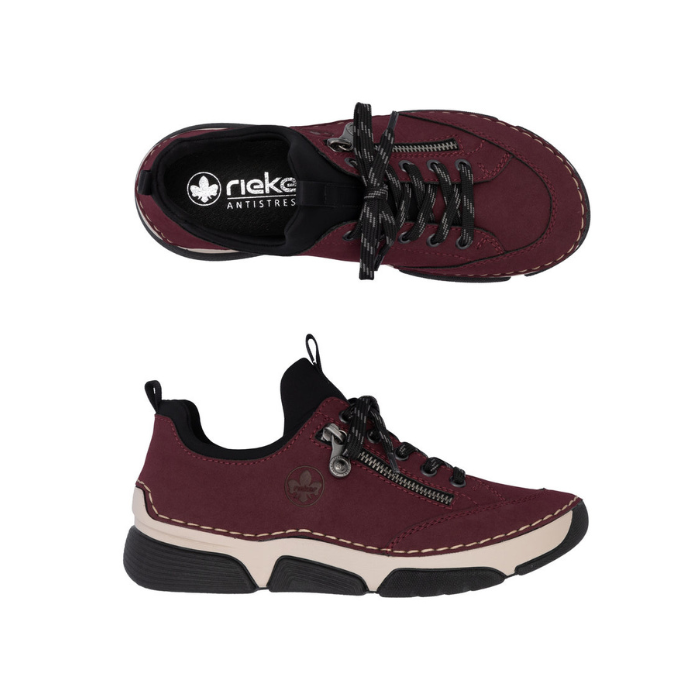 Pair of Deep red sneakers with  faux side zipper, black Rieker logo&#39;d footbed, accent stitching above the thick beige midsole and black outsole.
